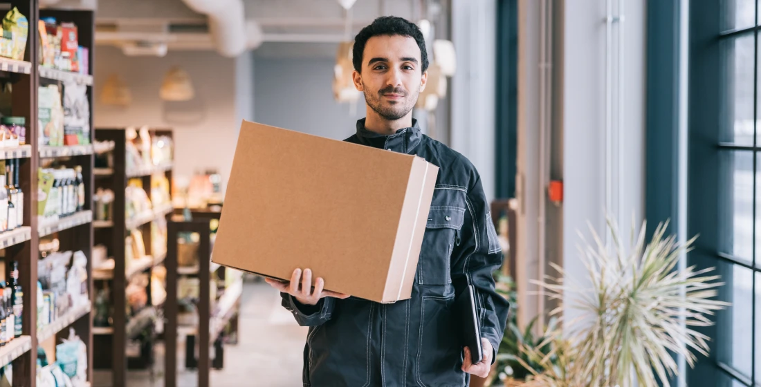 Man holding box in grocery aisle